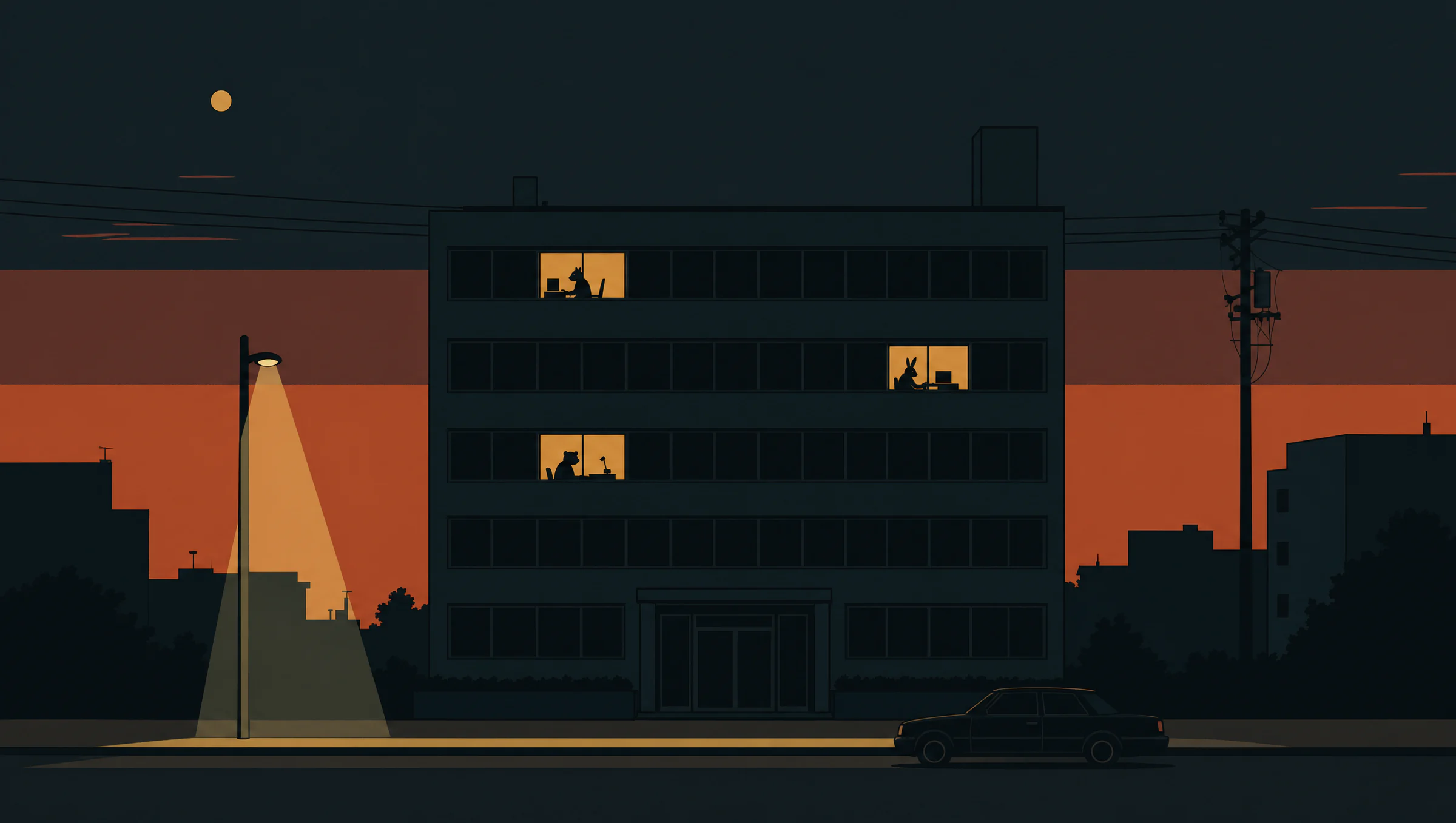 A dark office building at dusk with three windows still lit, an agent at work behind each one